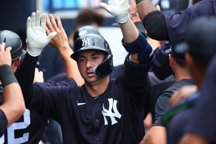 Yankees catcher Kyle Higashioka high fives dugout